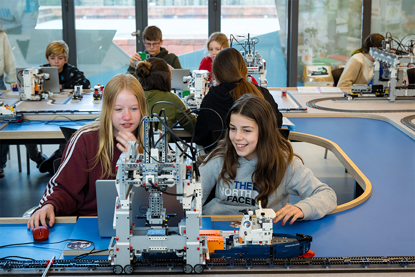 Twee meisjes van het secundair onderwijs leren programmeren en automatiseren met LEGO Education tijdens een STEM-workshop in de Havenstudio. © Havenwereld