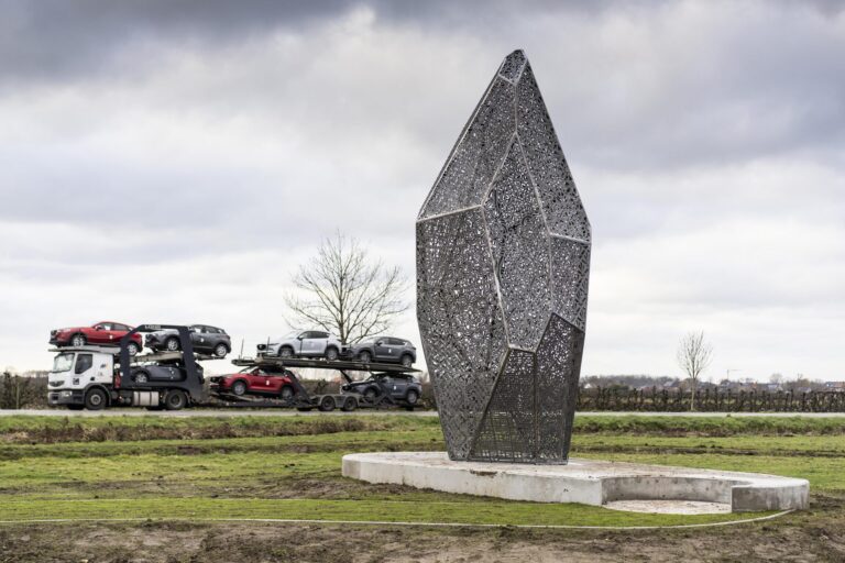 Foto van kunstwerk BAKEN bij een bewolkte hemel.